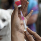 A health care worker in India preparing a rabies vaccine for a dog. Mass vaccination campaigns of pets have helped make human rabies infections a rarity in the U.S.